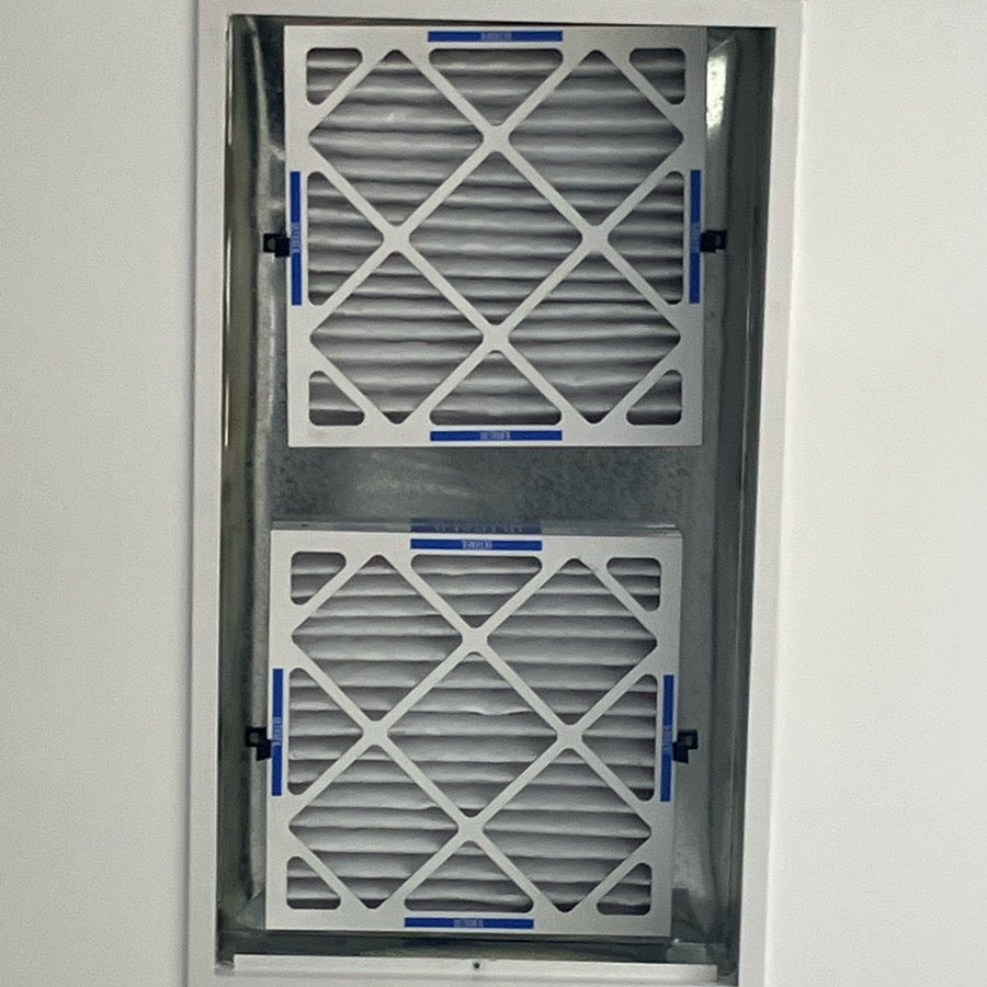 Two air filters mounted on a white ceiling